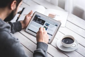 man searching on tablet for “removing my name from Google search”