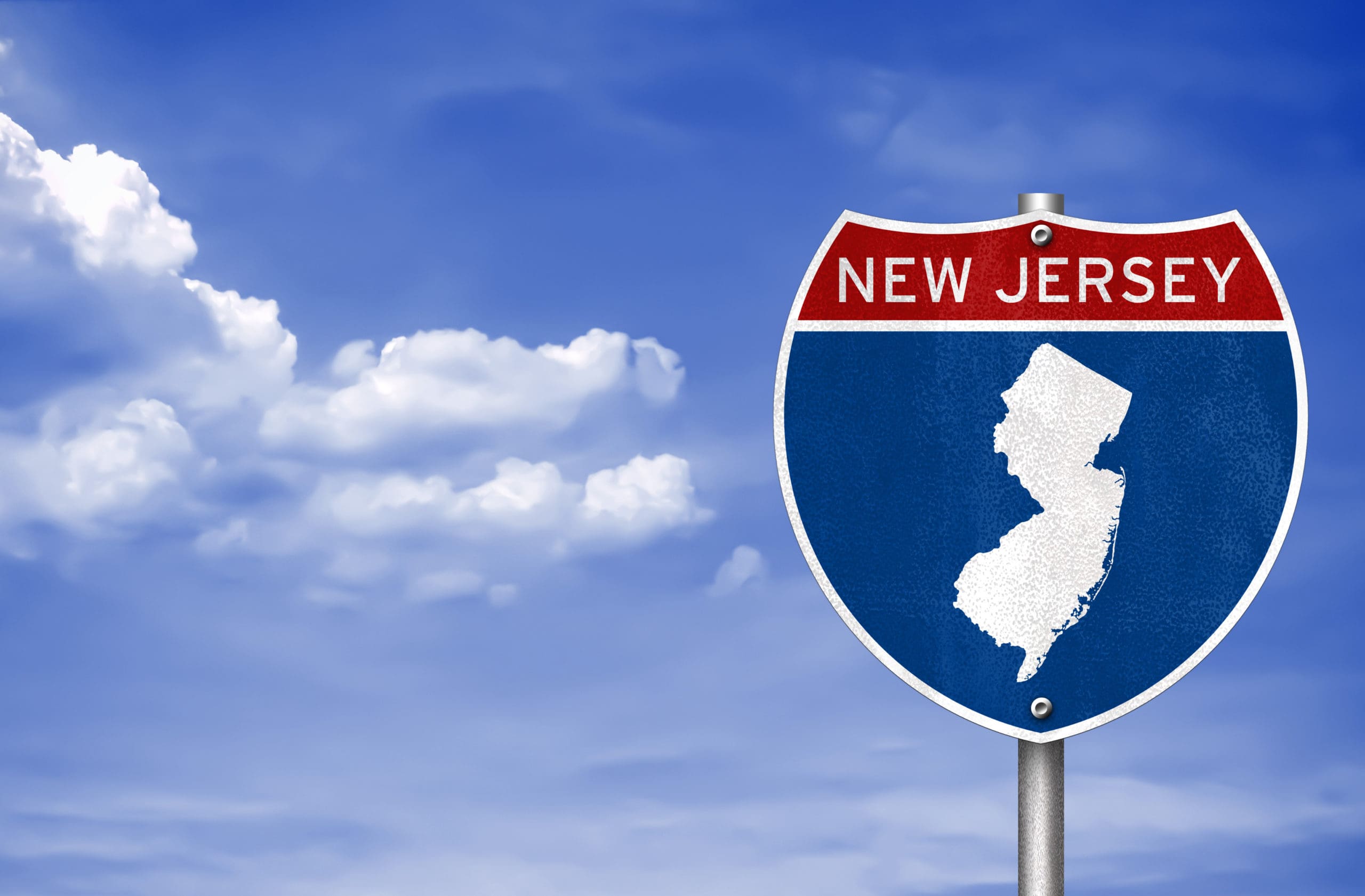 A new jersey road sign with a blue sky in the background.