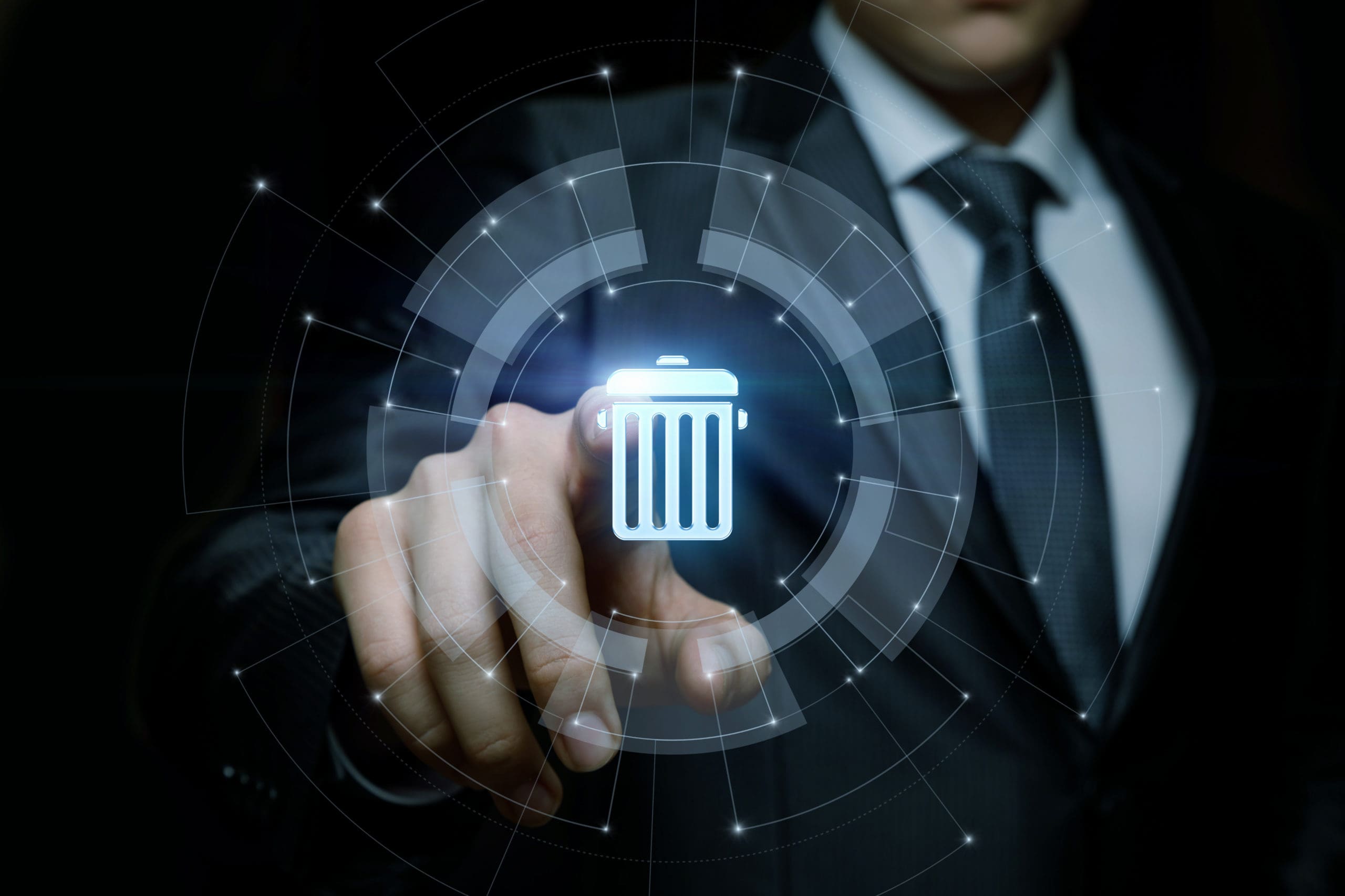 A man in a suit is pointing at a trash can icon.