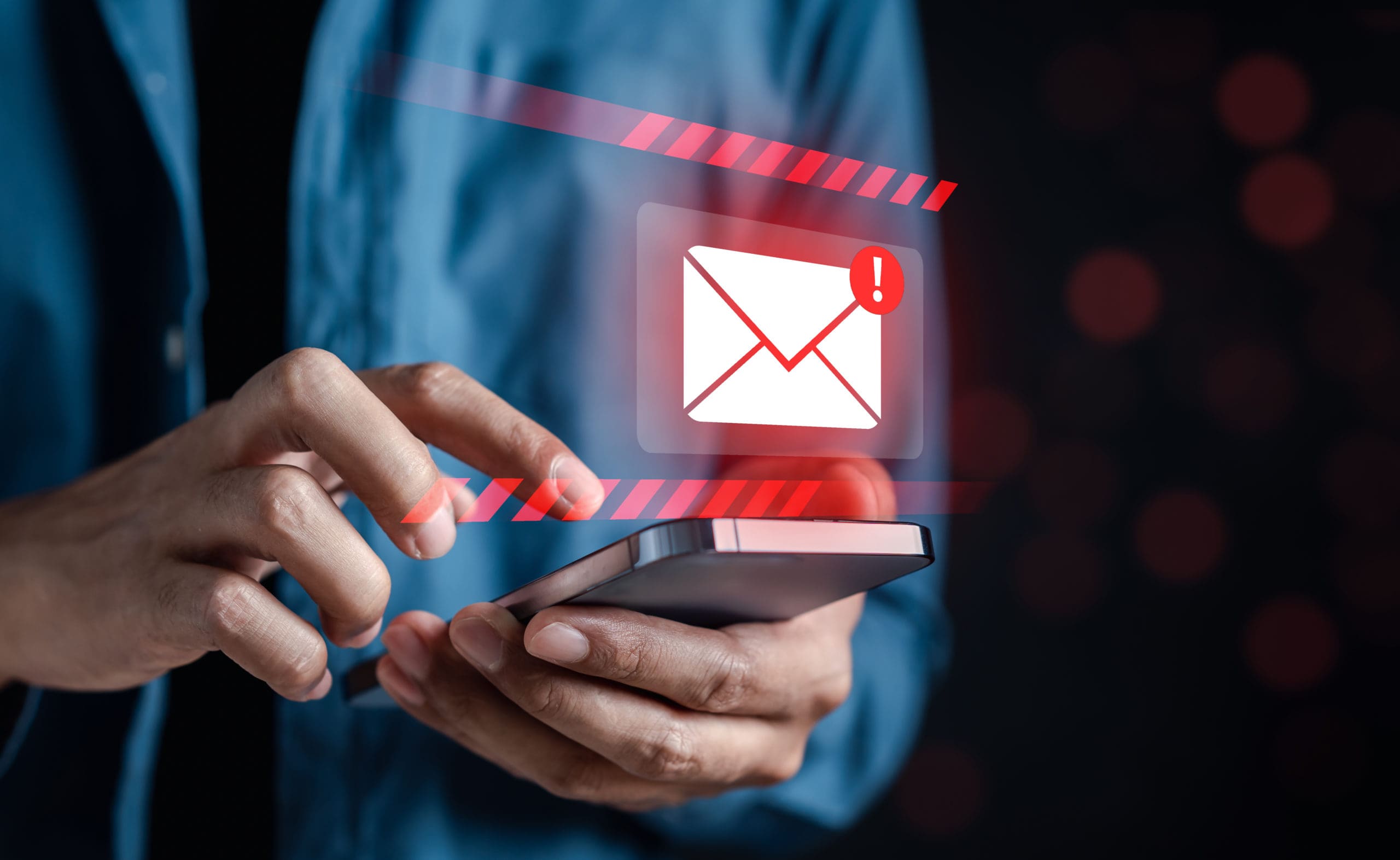 A man holding a phone with an email icon on it.